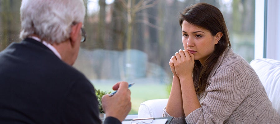concerned woman speaking with a counsellor