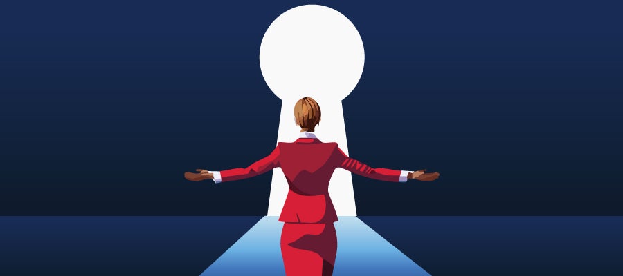 businesswoman standing in front of a glowing keyhole